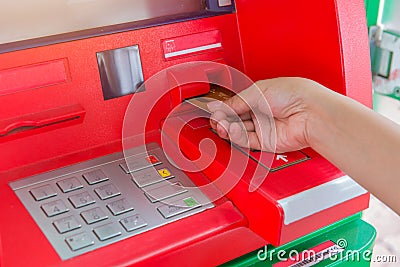 Hand insert credit card to ATM bank cash machine for withdraw mo Stock Photo