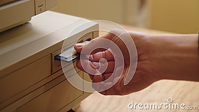 Hand inserting and ejecting Floppy Disk into vintage Commodore Amiga 2000 PC Stock Photo