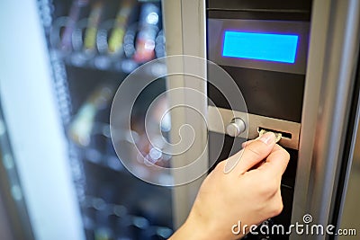 Hand inserting euro coin to vending machine slot Stock Photo