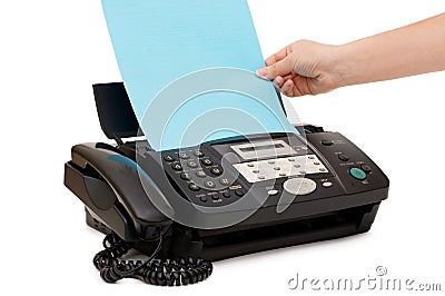 Hand inserts a paper into a fax Stock Photo