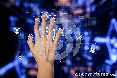 A hand interacts with a digital screen displaying multiple fingerprint icons Stock Photo