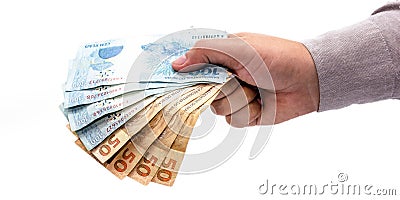 Hand on isolated white background offering brazil money, one hundred and fifty reais banknotes, brazilian economy Stock Photo