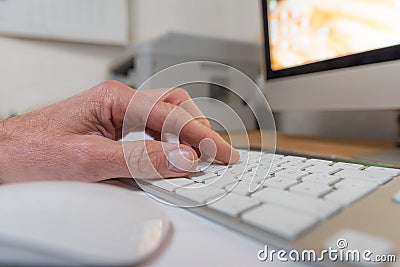 Hand on a keyboard with monitor and computermouse Stock Photo