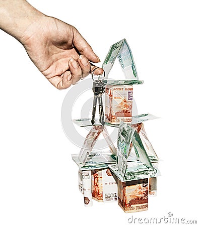 The hand with the keys on the background of the House of banknotes Stock Photo