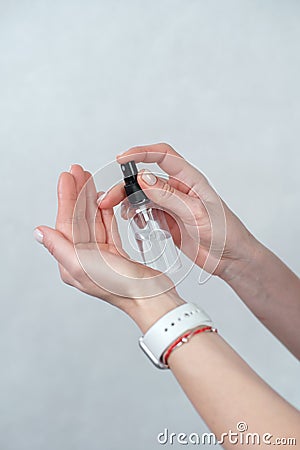 Hand of lady with watch that applying alcohol spray or anti bacteria spray to prevent spread of germs, bacteria and virus. Stock Photo