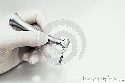 Hand with latex gloves hold instruments for surgeries, oral orthodontics, revision of teeth and dental appliances. Stock Photo