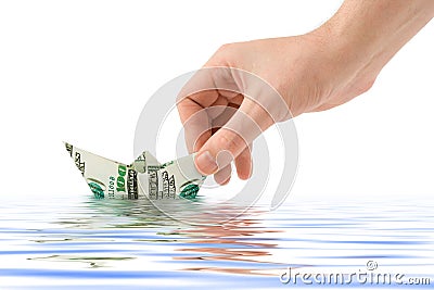 Hand launching money ship Stock Photo