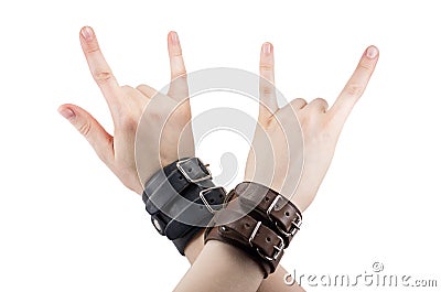 Hand with leather rocker bracelet with rock and roll sign, rock music isolated on white Stock Photo