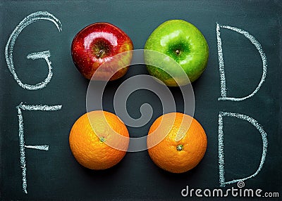 Hand Lettering Good Food on Black Chalkboard with Fruits Oranges Green Red Apples. Healthy Clean Eating Vegan. Vitamins Energy. Stock Photo