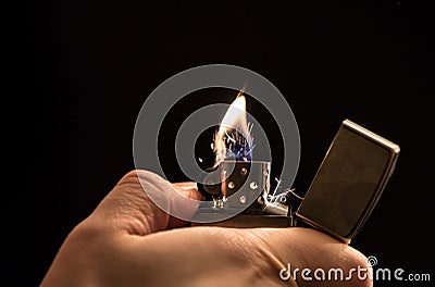 Hand and a lighter Stock Photo