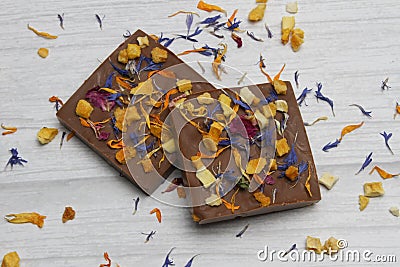 Hand made chocolate with freeze-dried mango and candied violet Stock Photo