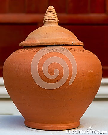 Hand made clay pot with lid Stock Photo