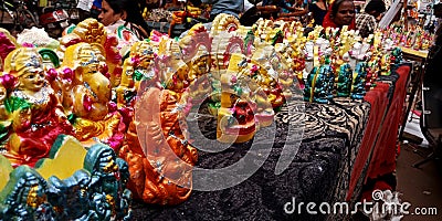 hand made devotional statue art gallery store of indian street during diwali festival in India Editorial Stock Photo