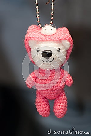 Hand made key ring brown teddy bear knitted doll wearing a pink shirt Stock Photo