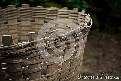 Hand made multipurpose basket made of bamboo on the ground on a mossy stone pile background Stock Photo