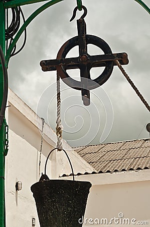 Hand made, water well pulley with a pale Stock Photo