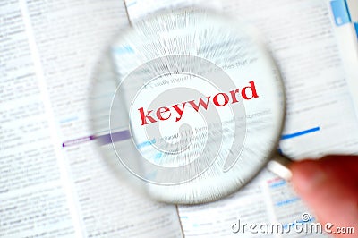 Hand magnifying keyword Stock Photo