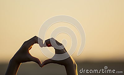Hand making a love heart shape. Stock Photo