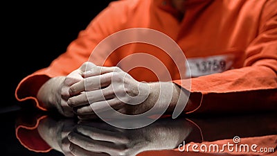 Hand of male prisoner, inmate giving evidence in detention room, cooperation Stock Photo