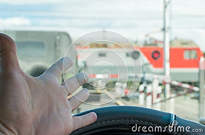 The hand of man inside the car. The car stopped in front of a closed barrier Stock Photo