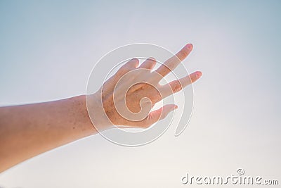 Hand of man reaching to towards sky. Hand make symbol Stock Photo