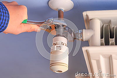 Hand of a man, repairman, installation radiator valve closeup Stock Photo