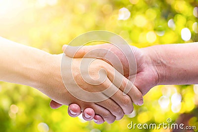Hand man Shake hands on green bokeh background Stock Photo