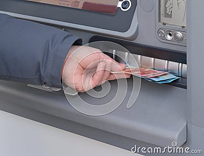 Hand of man to withdraw money from an ATM Stock Photo