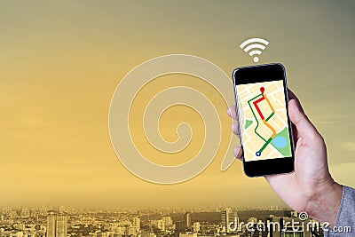 Hand of man using map on smartphone application with cityscape Stock Photo