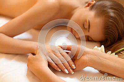 Hand Massage. Beautiful Blonde Gets Spa Treatment in Salon. Stock Photo