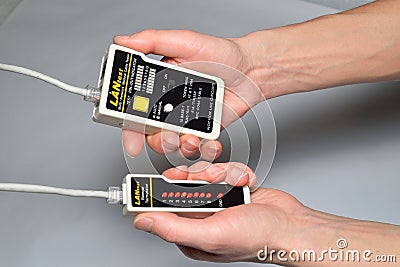 Hand of the master LAN check tester for crimped wire local area Stock Photo