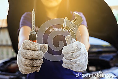 Hand mechanic engineer fixing,Car technician holding the screwdriver and spanner,concept car maintenance Stock Photo