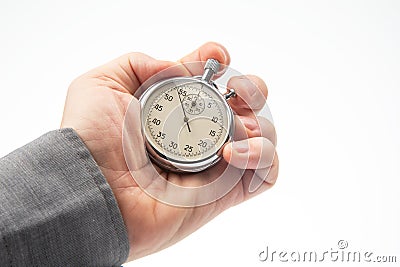 hand with a mechanical analog stopwatch on a white background. Time part precision. Measurement of the speed interval Stock Photo