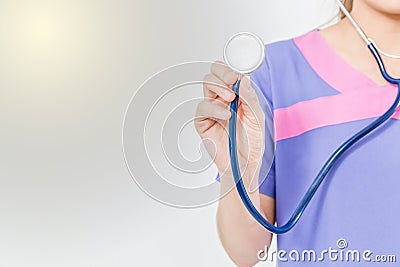 Hand of medical doctor and stethoscope on a white background holding a stethoscope focus on the stethoscope. Stock Photo