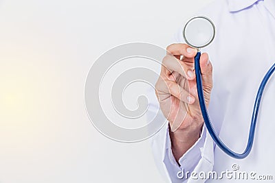 Hand of medical doctor and stethoscope on a white background holding a stethoscope focus on the stethoscope. Stock Photo