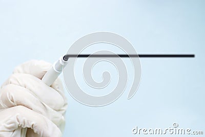 Hand in medical glove draws line with marker on glass, on blue background, copy space, mock up, medical concept Stock Photo