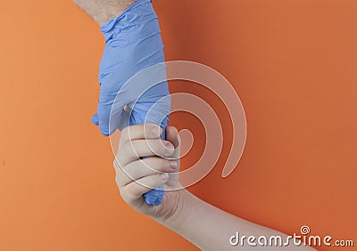 The hand in medical glove holding finger young boy Stock Photo