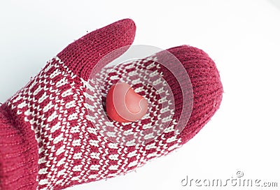 Hand in mitten holding red heart shape Stock Photo