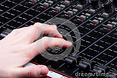 Hand on Mixing Console Stock Photo