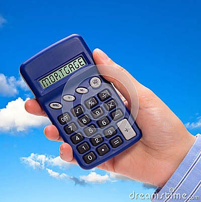 Hand with mortgage calculator Stock Photo
