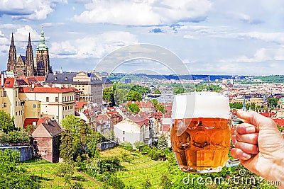 Hand with a mug of beer on the background of the panorama of Prague Stock Photo