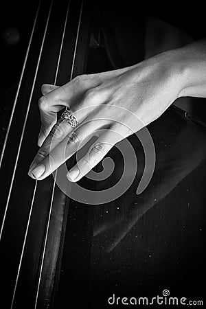 Hand of a musician playing on a contrabass closeup Stock Photo