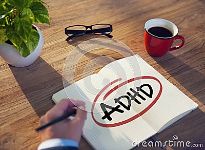 Hand with a Note and a Single Word ADHD Stock Photo