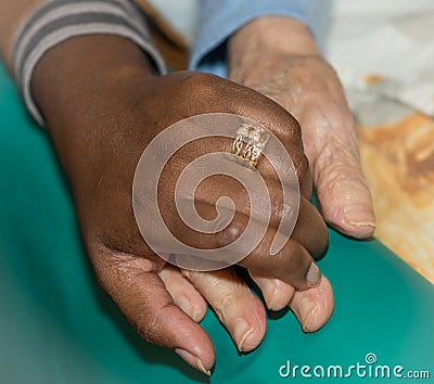 Hand of nurse holding a senior woman. Concept of helping hands, care for the elderly Stock Photo