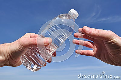 Hand Offering a Bottle of Water Stock Photo