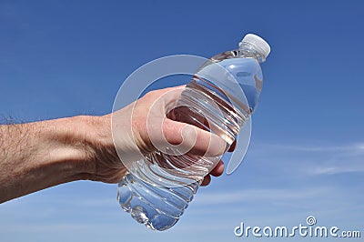 Hand Offering a Bottle of Water Stock Photo