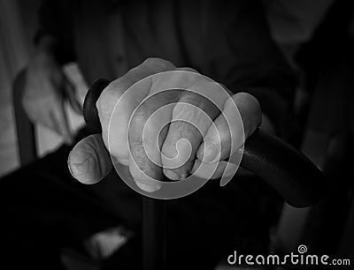 Hand old man on a plastic stick. Black and white photo. Stock Photo