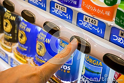 Hand of one people pressing to buy canned soft drink from Japan vending machine Editorial Stock Photo