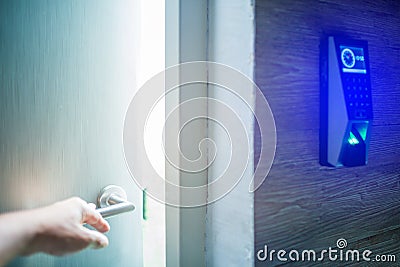 Hand open the door with finger scan access control system to unlock at safe room. blurry image Stock Photo