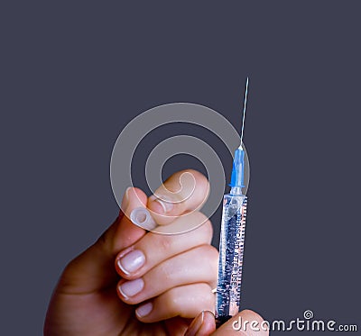 Hand with open medical syringe Stock Photo